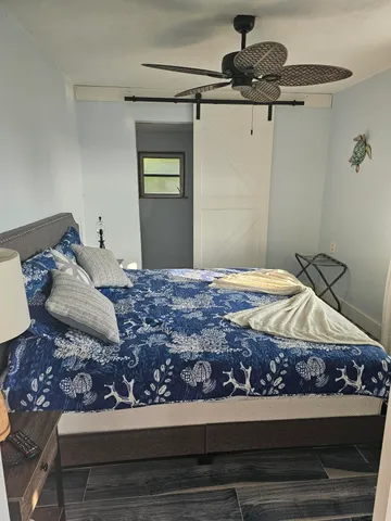 a white toilet sitting next to a shower