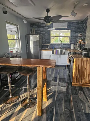 a kitchen with counter top space a sink and appliances