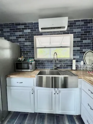 a kitchen with cabinets a window and stainless steel appliances