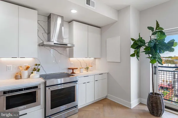a kitchen with a white stove and white cabinets
