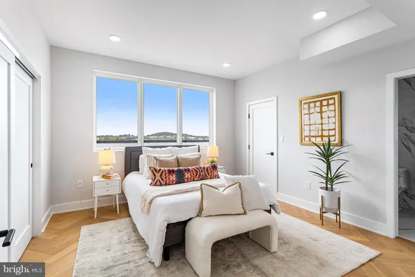 a bedroom with furniture and a potted plant