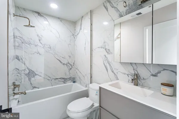 a bathroom with a sink a toilet and a bathtub