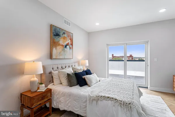 a bedroom with bed and night stand