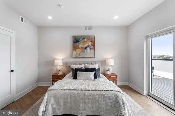 a bedroom with a bed and a painting on the wall