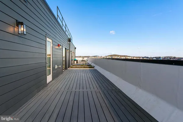 a view of balcony with wooden floor and fence