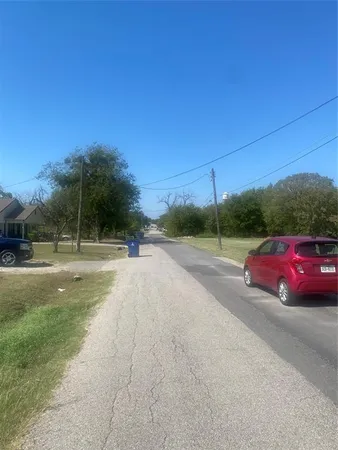a view of street with a car parked on road