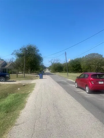 a view of street with a car parked on road