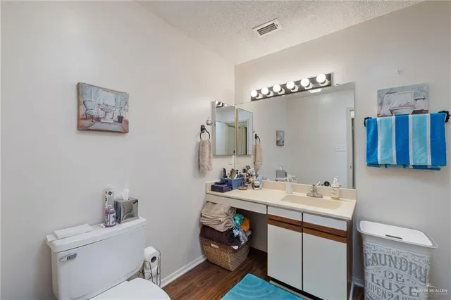 a bathroom with a sink toilet and a mirror