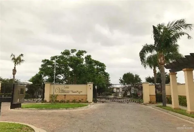 a row of palm trees in front of house