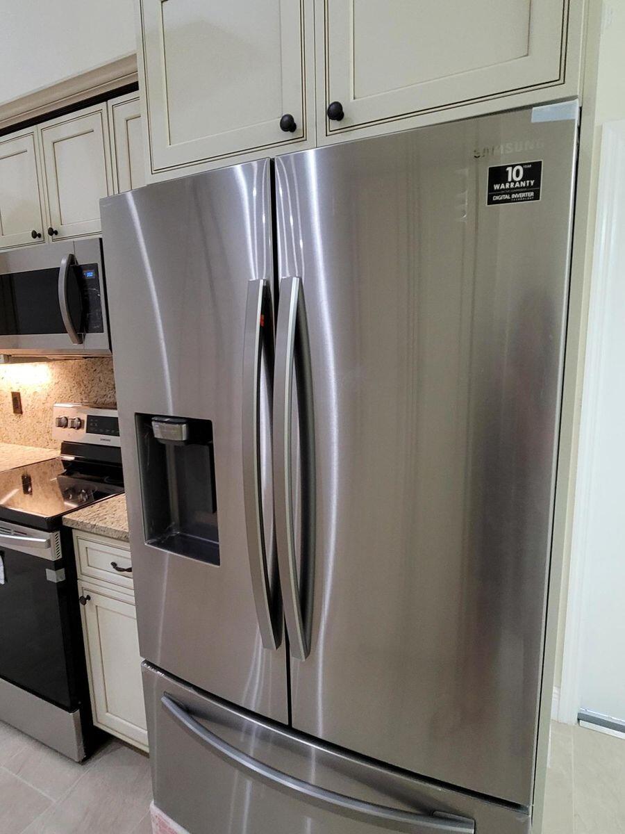 11000 Ladera Lane, Unit B Boca Raton, FL 33498 - Photo 13 of 29 a view of a refrigerator and microwave