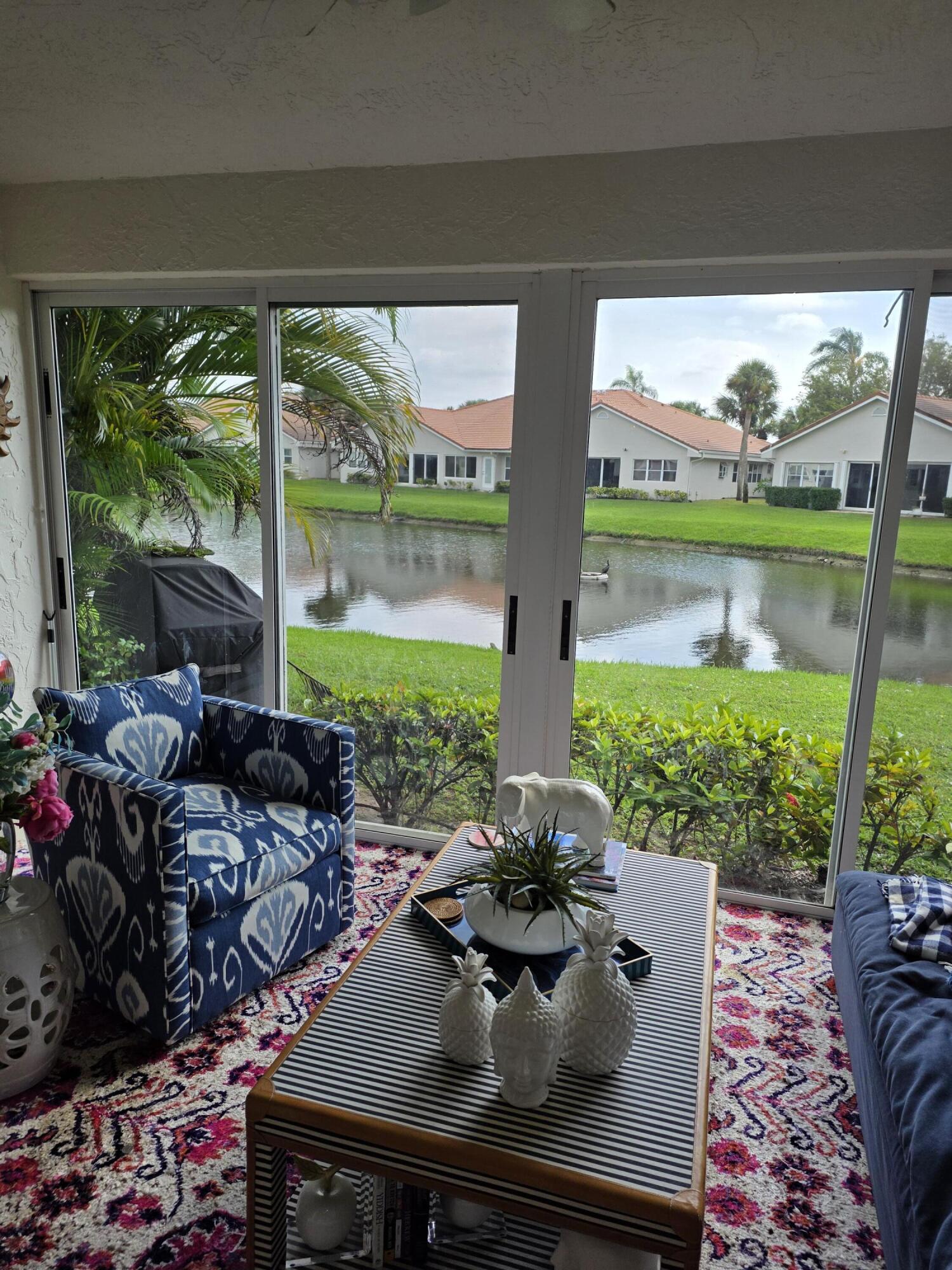 11000 Ladera Lane, Unit B Boca Raton, FL 33498 - Photo 2 of 29 a view of a living room and floor to ceiling windows