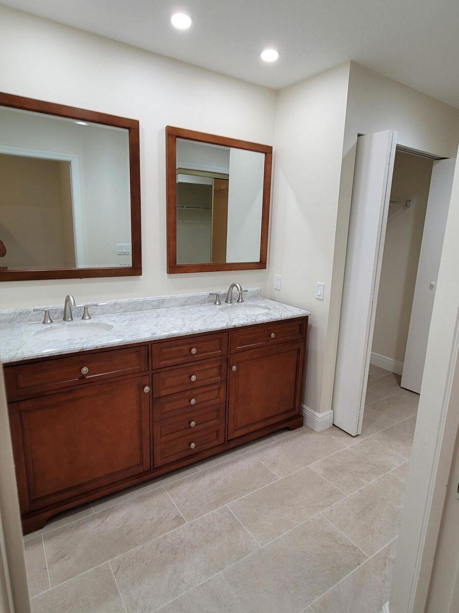 11000 Ladera Lane, Unit B Boca Raton, FL 33498 - Photo 21 of 29 a spacious bathroom with a granite countertop sink and a mirror