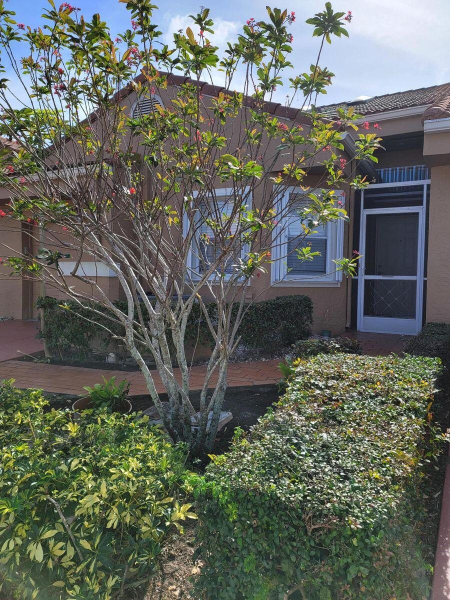 11000 Ladera Lane, Unit B Boca Raton, FL 33498 - Photo 27 of 29 a front view of a house with a yard