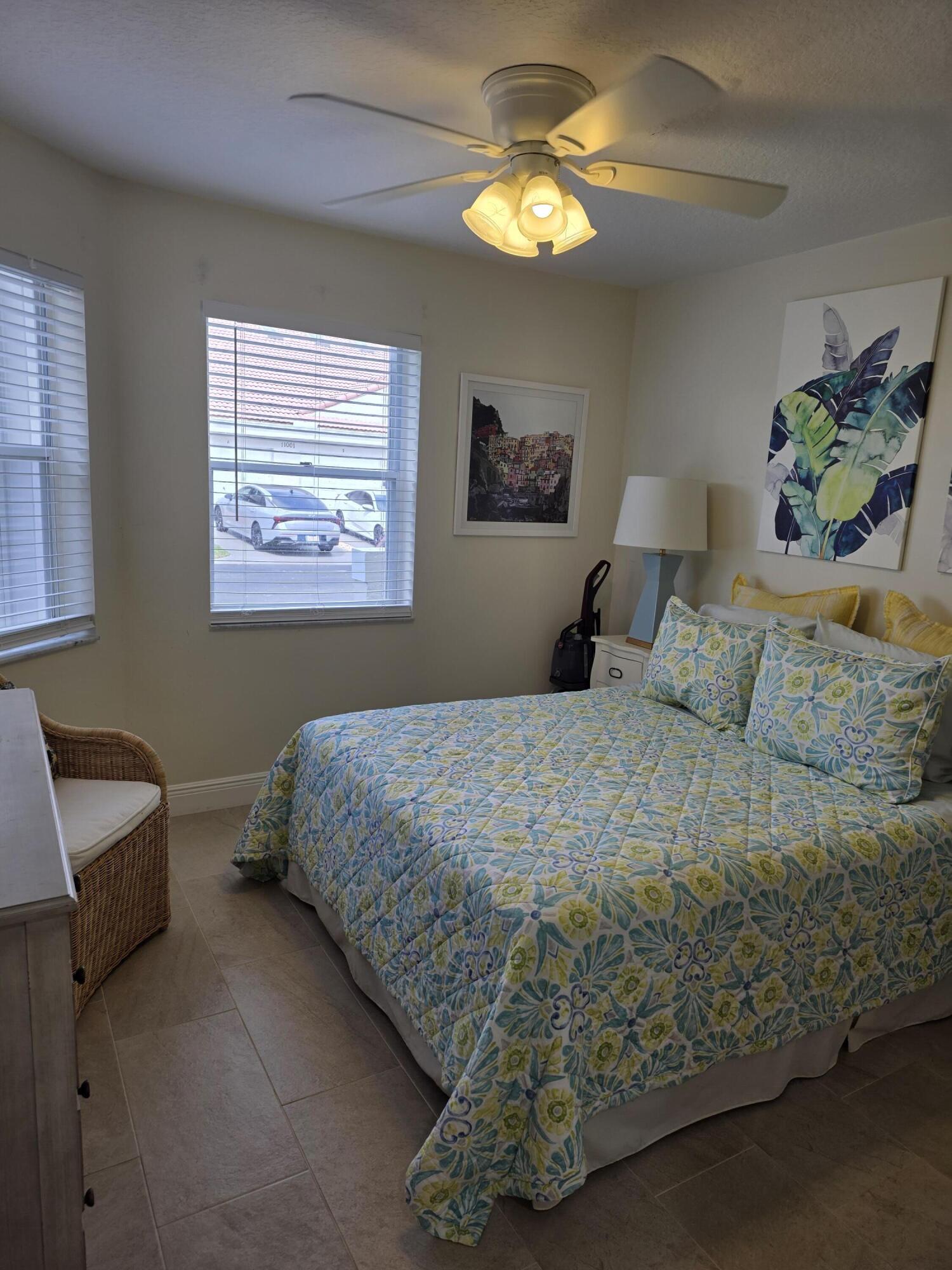 11000 Ladera Lane, Unit B Boca Raton, FL 33498 - Photo 3 of 29 a bedroom with a bed and a chandelier