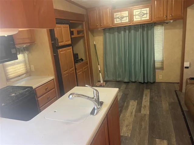 a bathroom with a granite countertop sink a mirror and shower