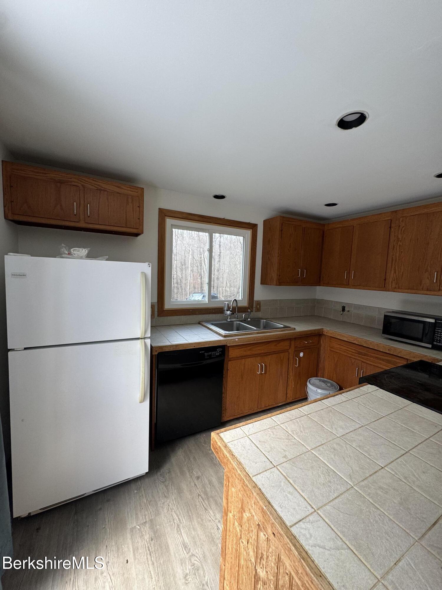 271 Brodie Mountain Road Hancock, MA 01237 - Photo 6 of 27 a kitchen with stainless steel appliances granite countertop a refrigerator a sink and a stove