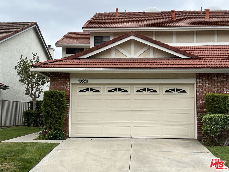 a front view of a house with garage