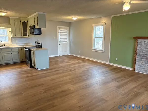 a kitchen with granite countertop a stove top oven sink and cabinets