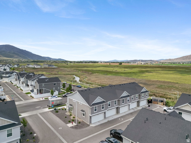 1223 East 1775 North Payson, UT 84651 - Photo 17 of 45 Modern row of townhomes featuring grey siding, white trim, attached garages, and dark shingle roofs