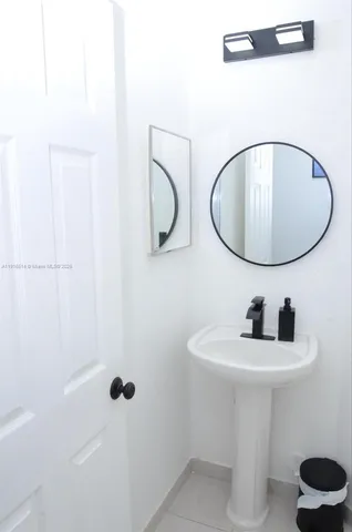 a bathroom with a sink a toilet and mirror