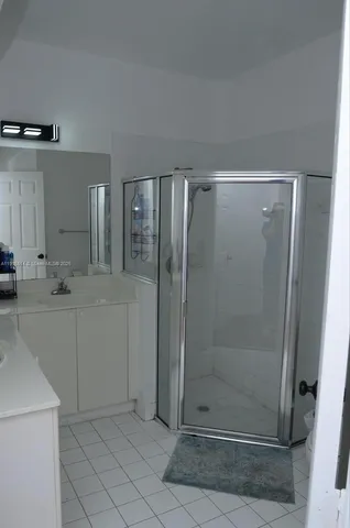 a bathroom with a shower and a sink