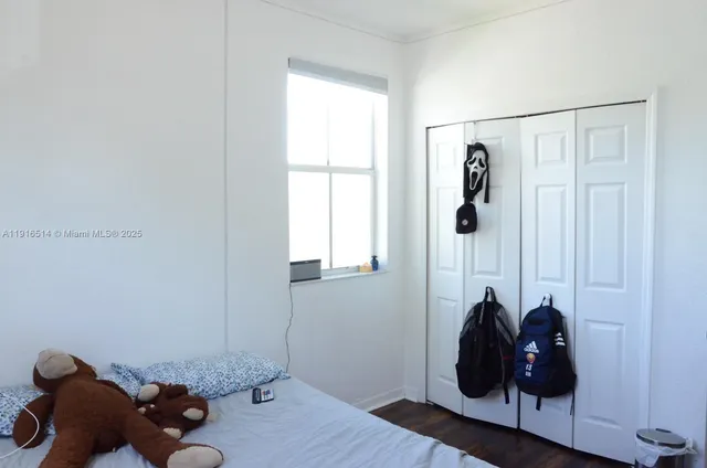 a room with a window and wooden floor