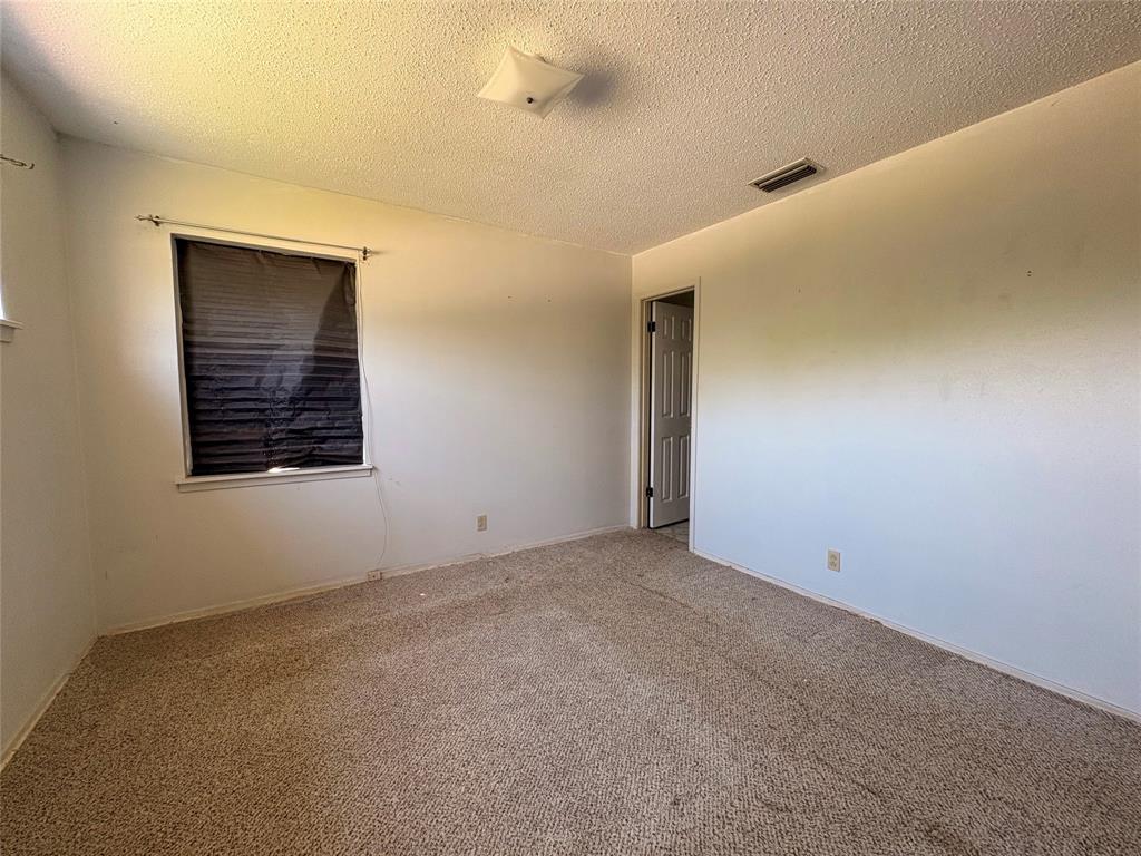 1829 South Center Street Denison, TX 75021 - Photo 24 of 29 a view of an empty room with a window