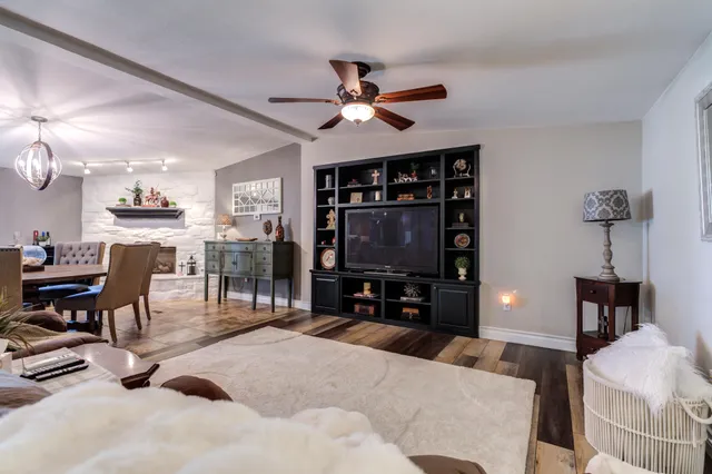 a view of a dining room with furniture and a fireplace