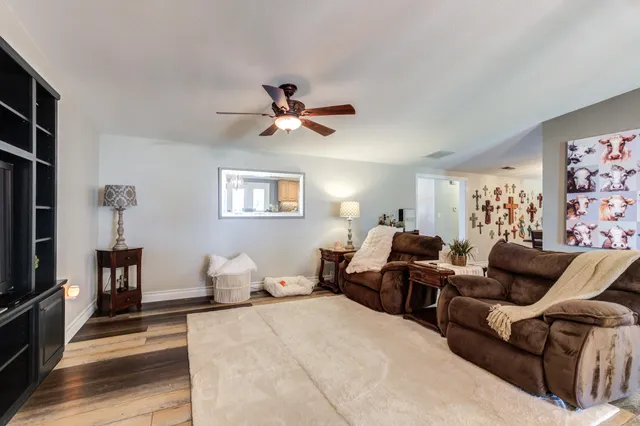 a bedroom with a bed a couch and a flat screen tv