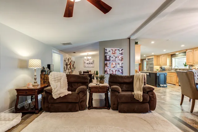 a living room with furniture fireplace and flat screen tv
