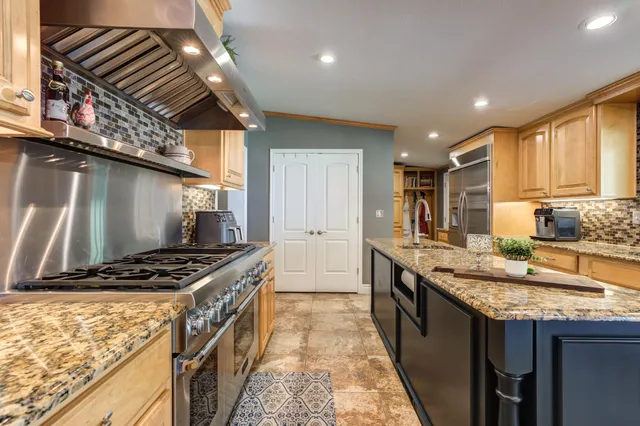 a very nice looking dining room with kitchen island furniture and a ceiling fan