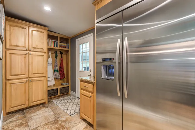 a bedroom with bed and a chandelier
