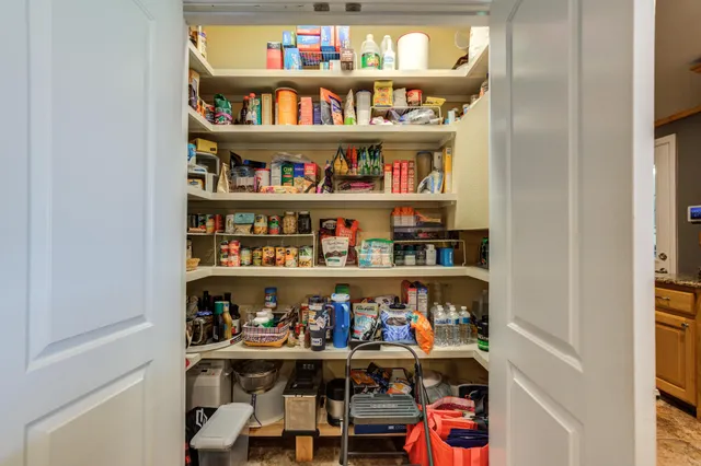 a bedroom with a bed a couch and a window