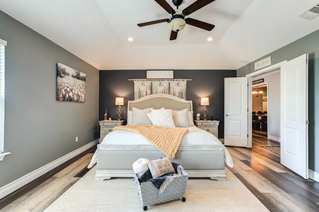 a bedroom with bed and a chandelier