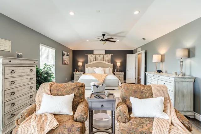 a view of a patio with table and chairs with wooden fence