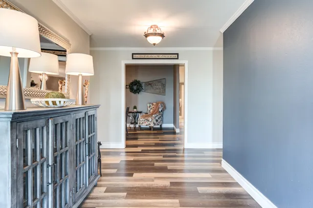 a living room with furniture a dining table and a flat screen tv