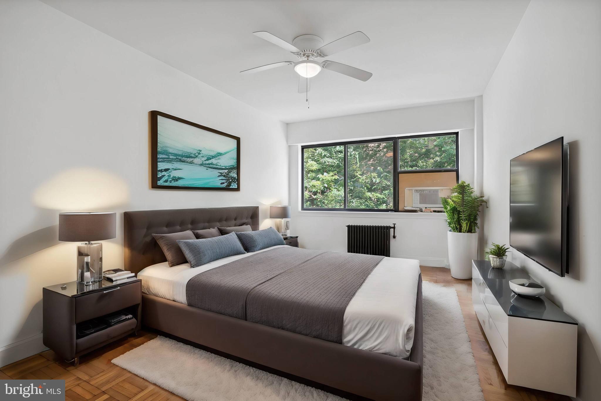 3901 Tunlaw Road Northwest, Unit 502 Washington, DC 20007 - Photo 13 of 34 a bedroom with a large bed and a flat screen tv