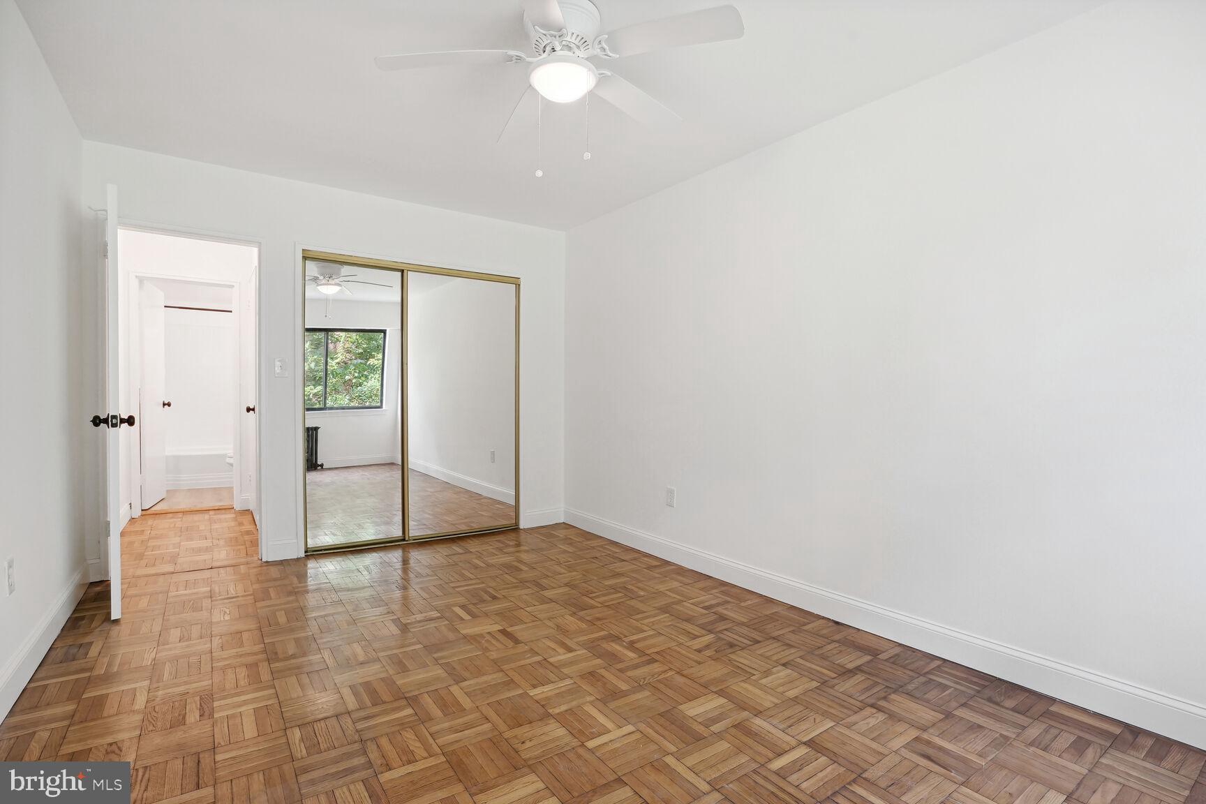 3901 Tunlaw Road Northwest, Unit 502 Washington, DC 20007 - Photo 14 of 34 wooden floor in an empty room