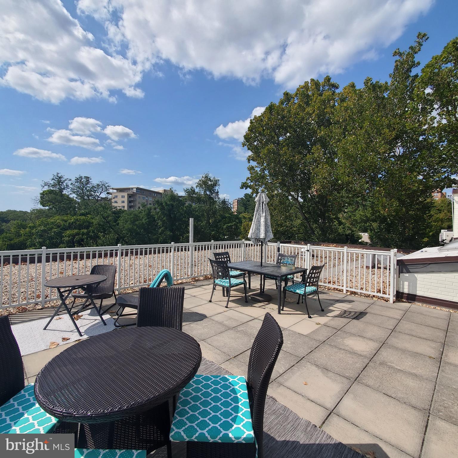3901 Tunlaw Road Northwest, Unit 502 Washington, DC 20007 - Photo 24 of 34 a view of a patio with couches table and chairs and potted plants