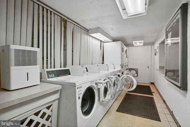 a view of a hallway with washer and dryer