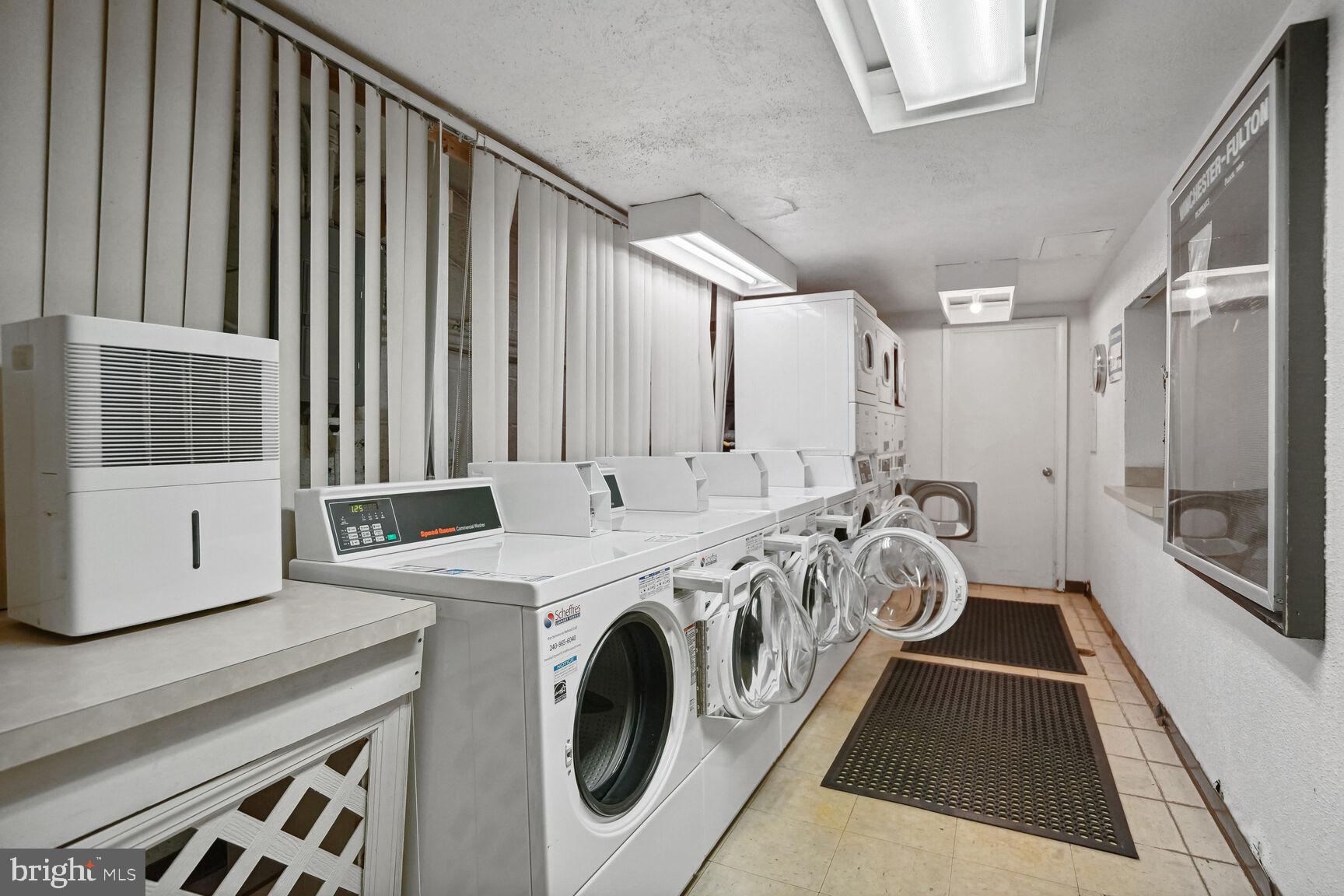 3901 Tunlaw Road Northwest, Unit 502 Washington, DC 20007 - Photo 27 of 34 a view of a hallway with washer and dryer