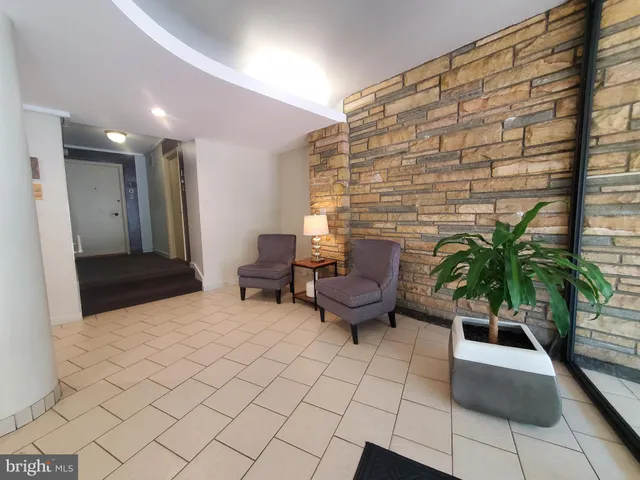 a lobby with furniture and a potted plant