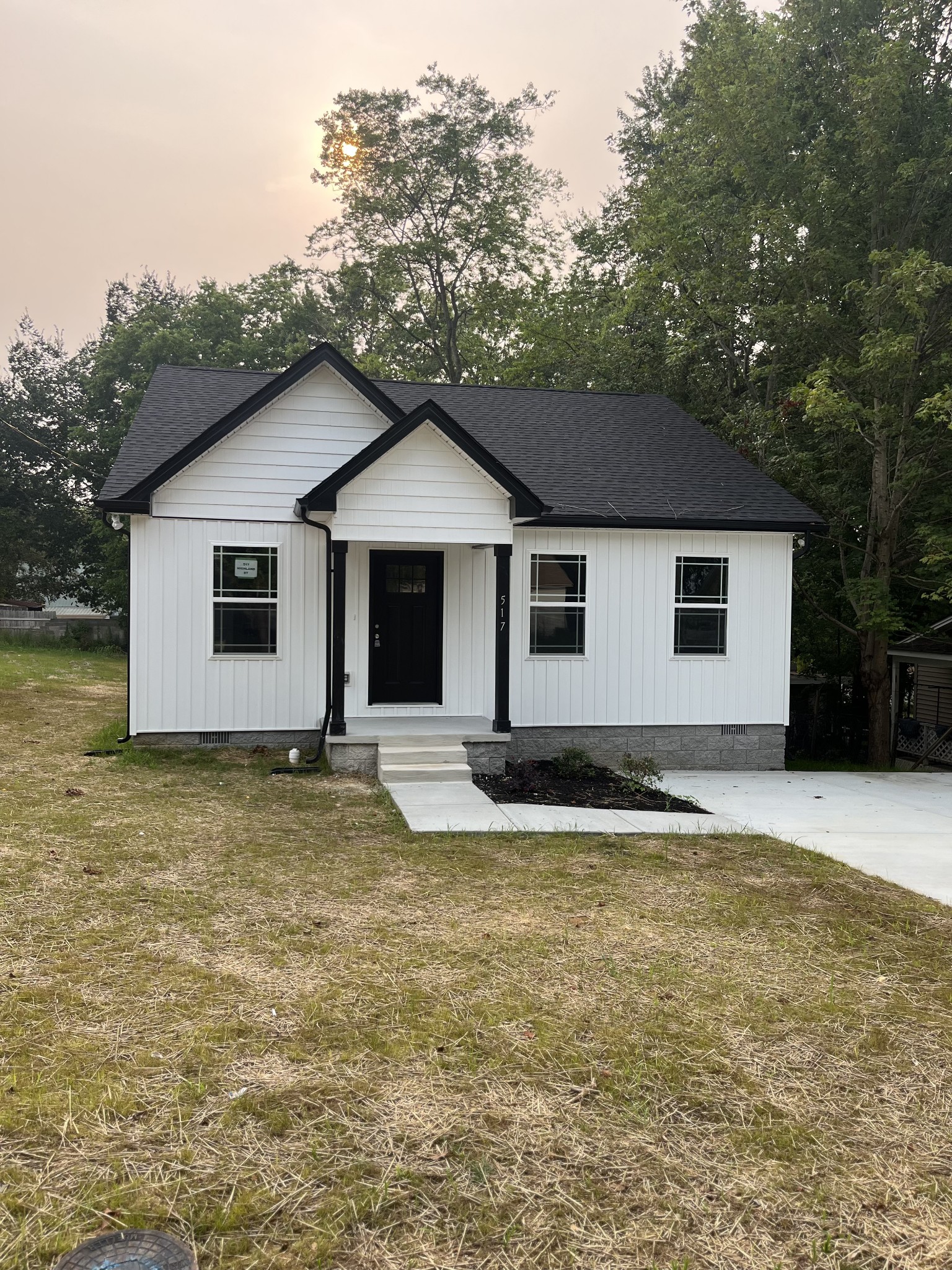 a view of a house with a yard and garage