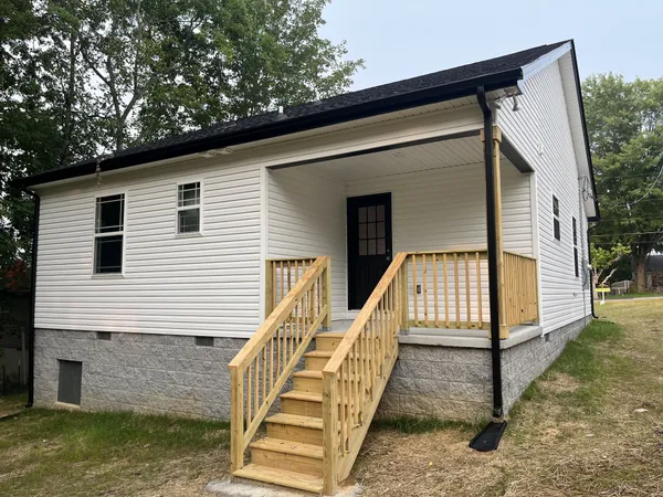 a view of front door of house with stairs