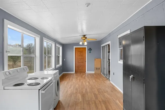 a view of a kitchen with a sink and dishwasher wooden cabinets
