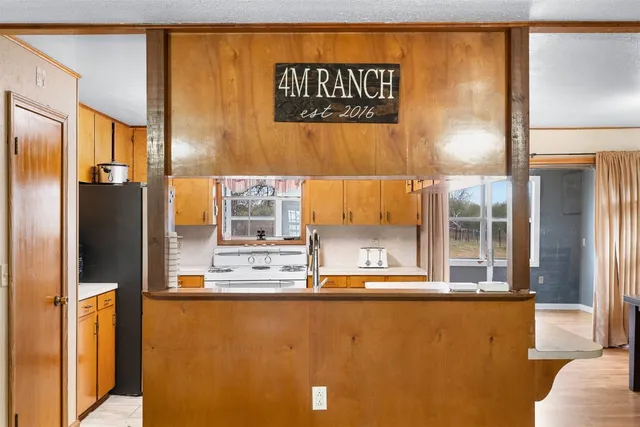 a view of a kitchen with a refrigerator and a cabinets