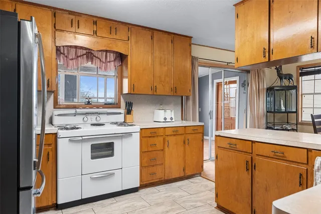 a kitchen with stainless steel appliances granite countertop a stove and a refrigerator