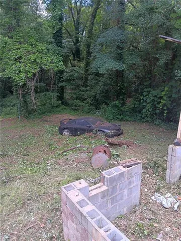 a view of a yard with large trees