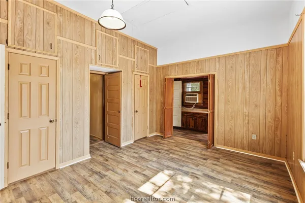 a view of a room with wooden floor and entryway