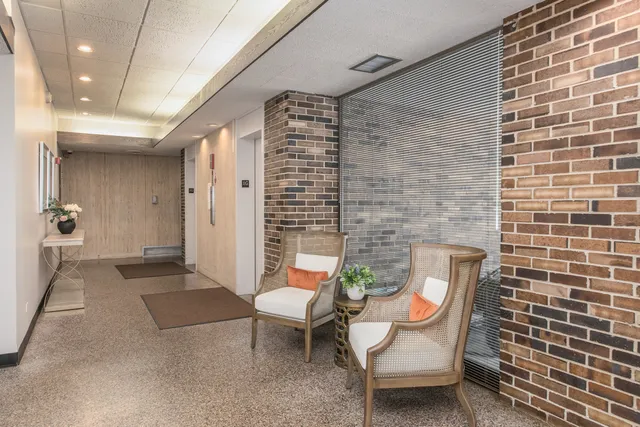 a view of a patio with a table and chairs and potted plants